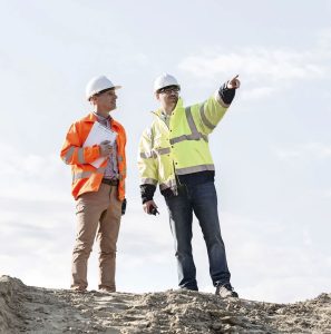 two construction workers talking to each other